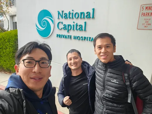 Three fellows outside National Capital Private Hospital