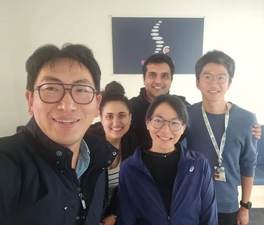 Team selfie with an ISSLS 2024 conference lanyard