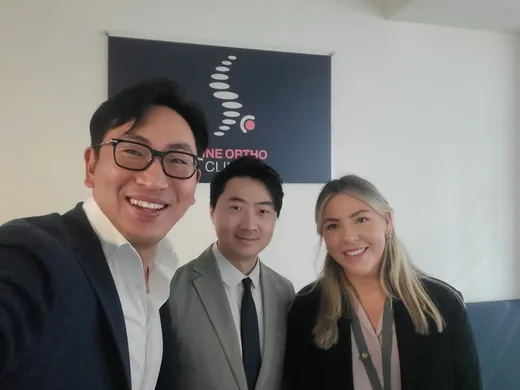 Fellows with practice staff under the clinic logo